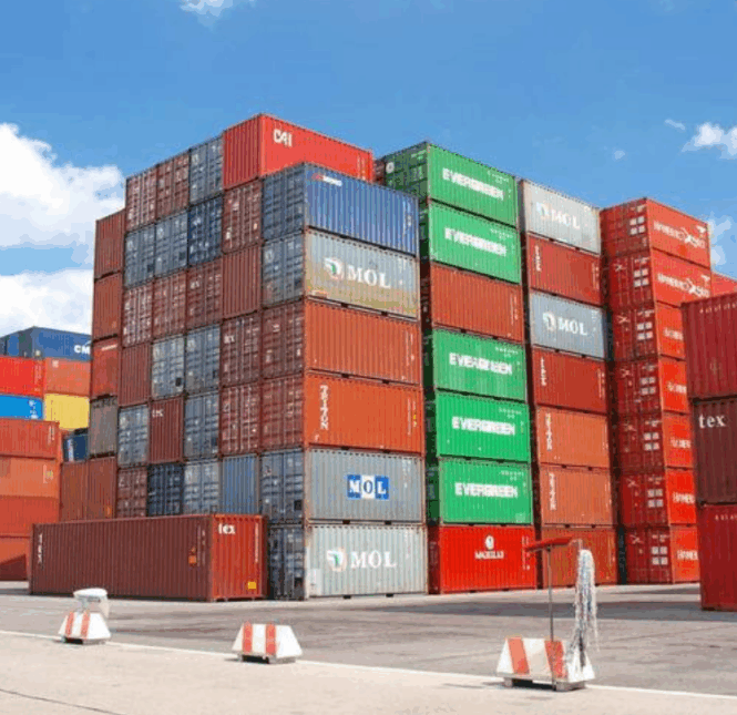Stacked FCL shipping containers at freight yard ready for international transport
