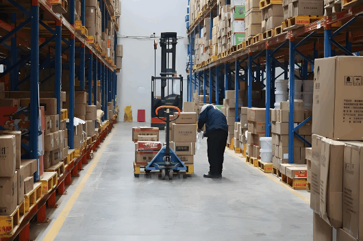 FCL shipping warehouse with forklift handling packed goods for export logistics